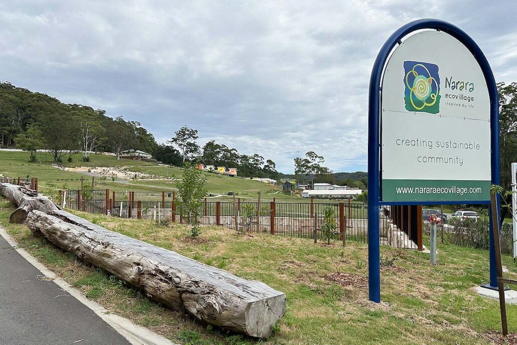 Narara ecovillage entrance sign with houses in the background
